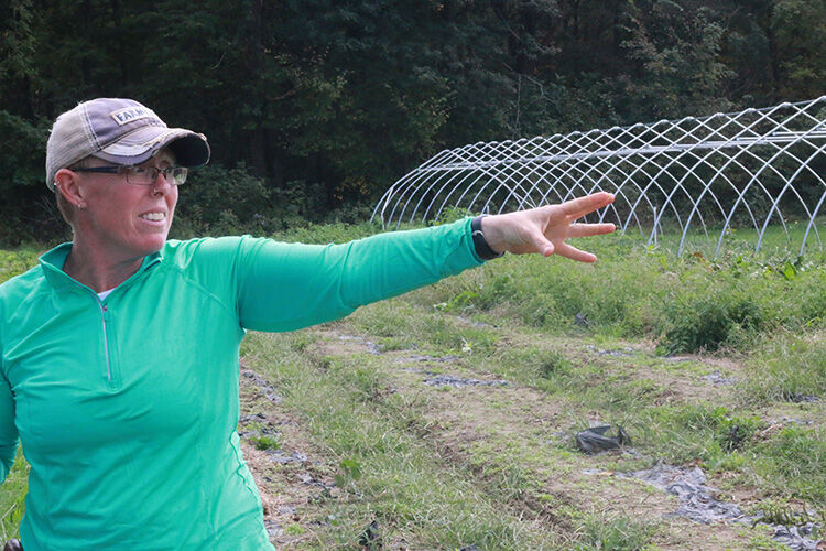 Liz Graznak gestures toward a crop